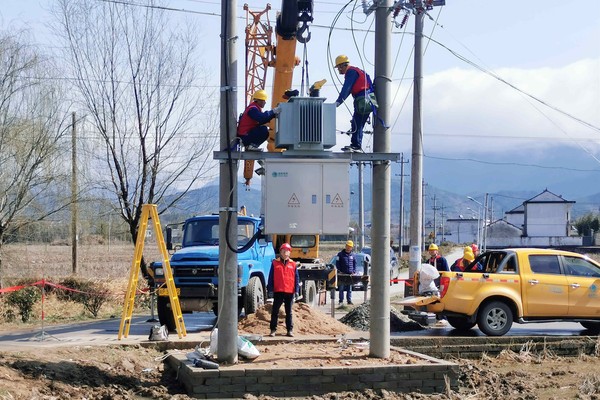安徽宣城旌德供电公司员工在10千伏古城111线82号杆上安装变压器